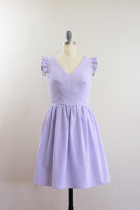 Elisabetta Bellu SS2020 Iris handmade lavender cotton seersucker short dress with gathered skirt and ruffled armholes V neck front
